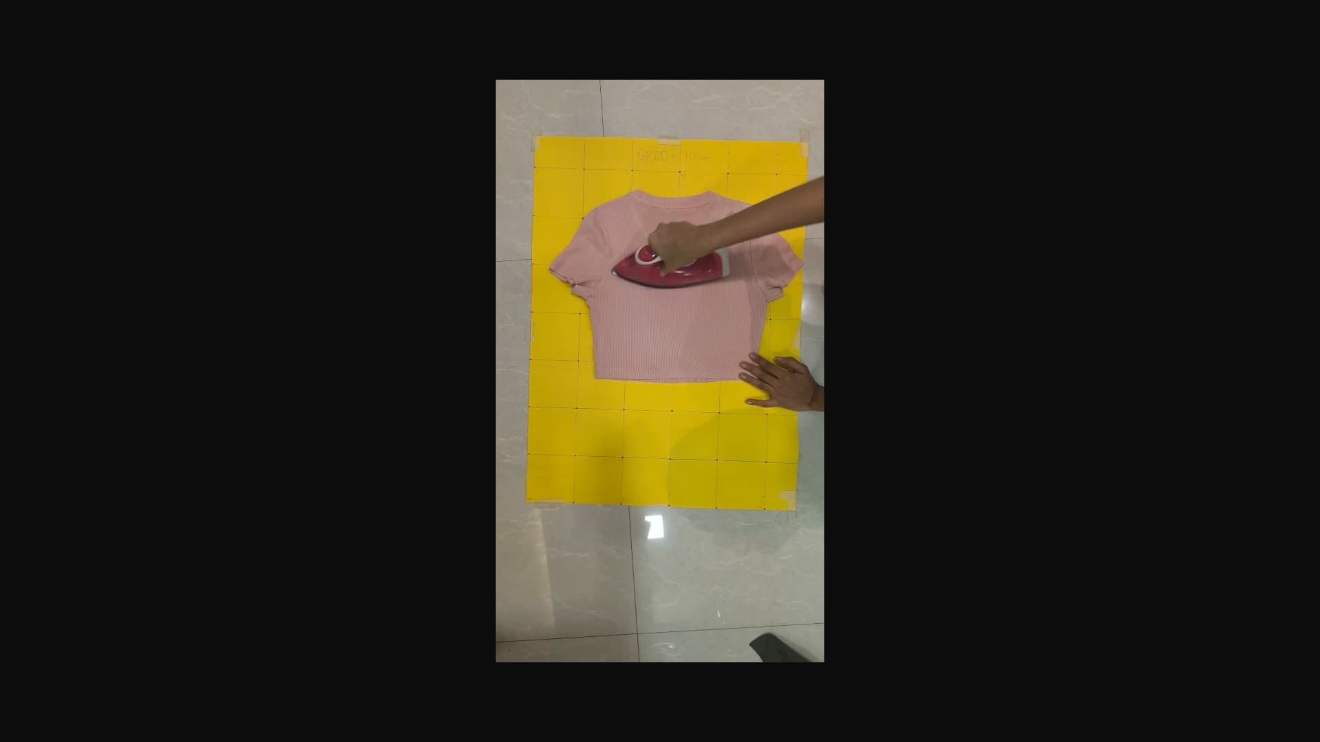 Original RGB frame from the real IRON_009 ironing episode, showing the garment, iron, and operator interaction